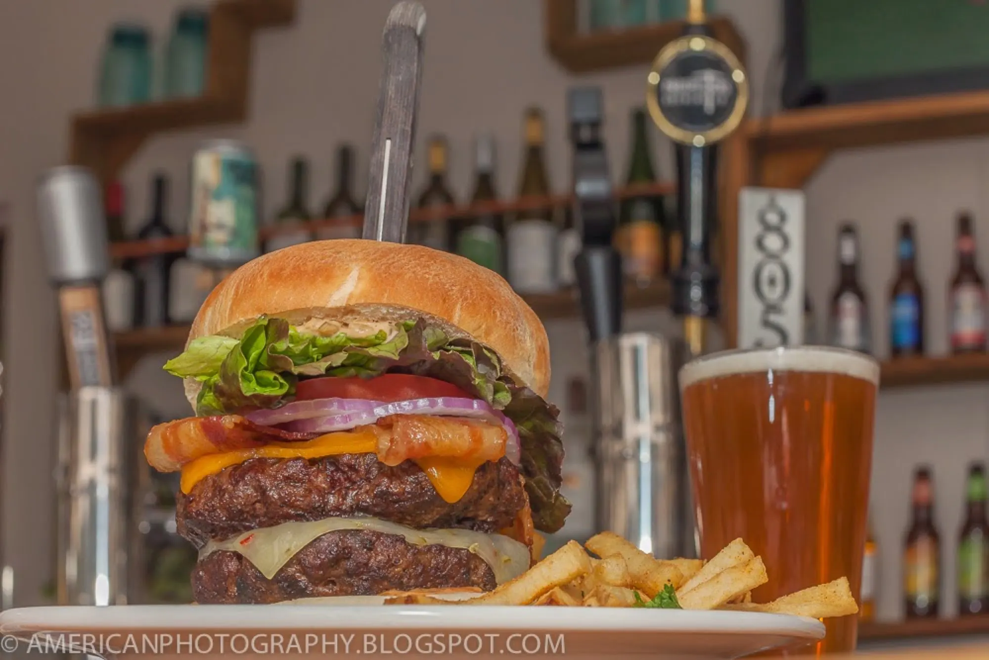 A burger, fries, and a beer served at 1850 Restaurant and Brewing Company